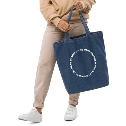 Close-up of the circular quote design on the denim tote's front panel