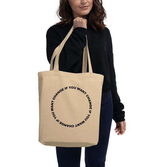 Organic cotton eco tote bag with black circular quote design, carried over the shoulder