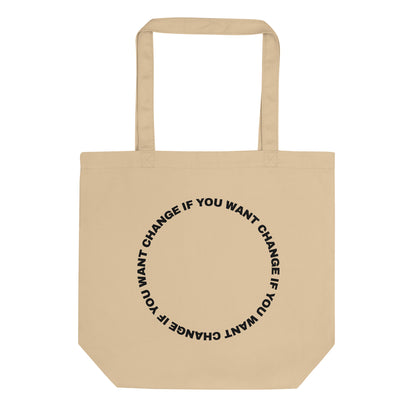 Black text loop reading change if you want change wrapped in a circle on a small organic cotton tote bag