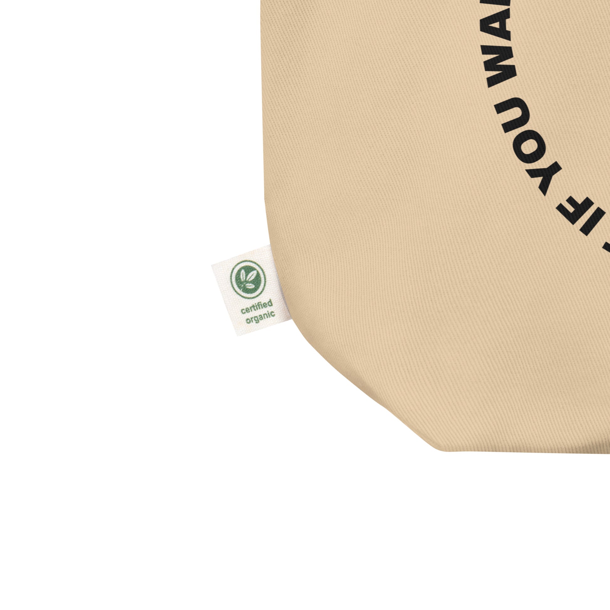 Close-up of the black circular quote design on the eco tote's front panel