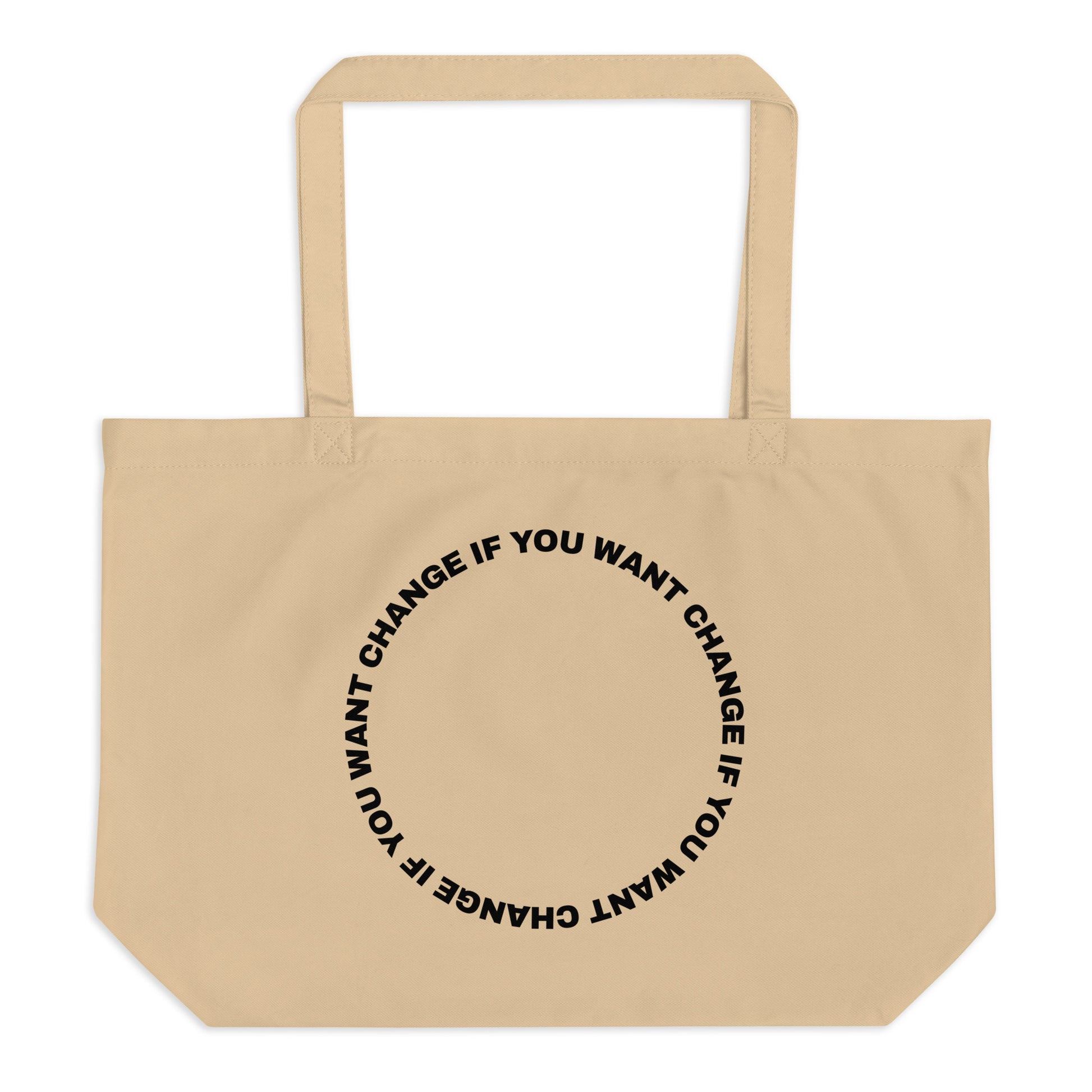 Black text in loop: "change if you want change" wrapped in a circle on an organic cotton tote bag
