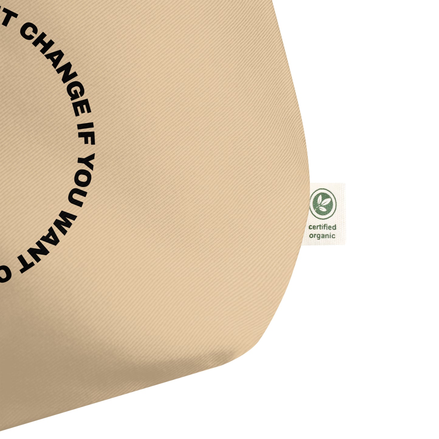 Close-up of the black circular quote design on the tote bag's front panel