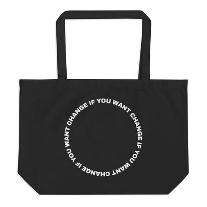 White text loop reading change if you want change wrapped in a circle on an organic cotton tote bag