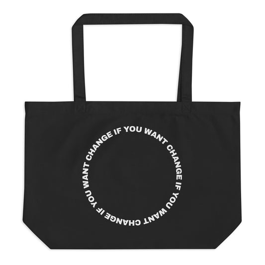 White text loop reading change if you want change wrapped in a circle on an organic cotton tote bag