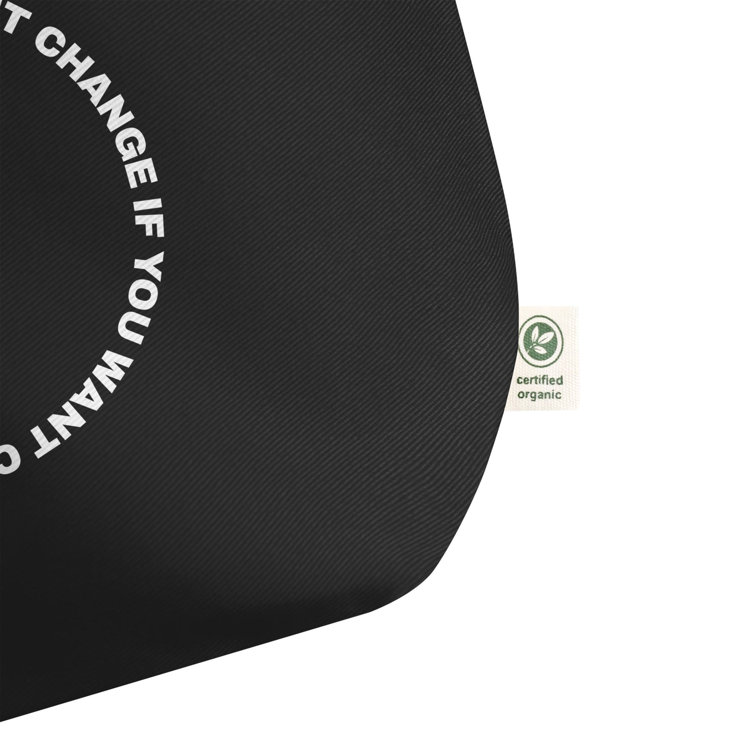 Close-up of the white circular quote design on the tote bag's front panel