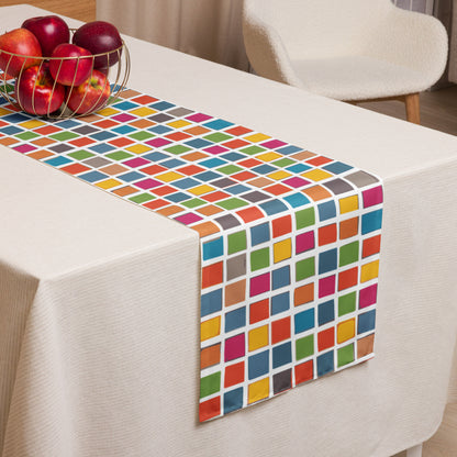 Colorful mosaic table runner with a vibrant all-over pattern of slightly tilted squares in orange, red, green, blue, magenta, and yellow on a white background.
