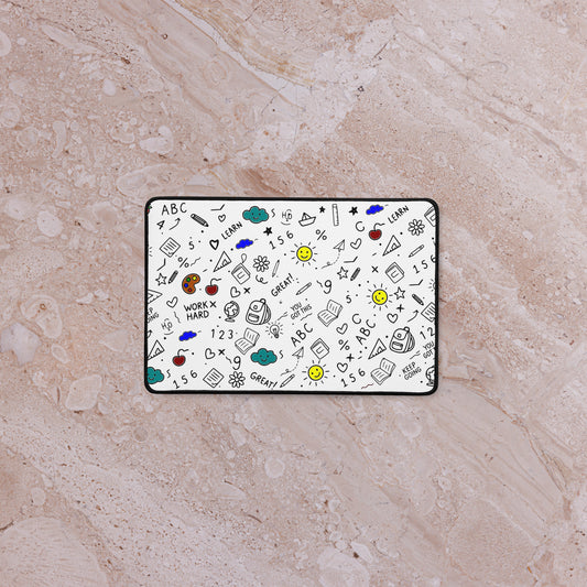 School doodle desk mat styled on a work-from-home setup — anti-slip rubber base, hemmed edges, flat lay view