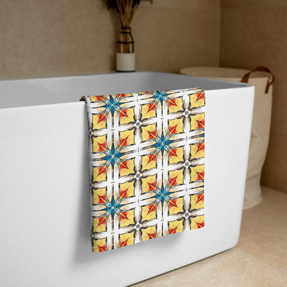 Fuego & Flow all-over print towel in fiery yellow, red and turquoise geometric pattern, small size