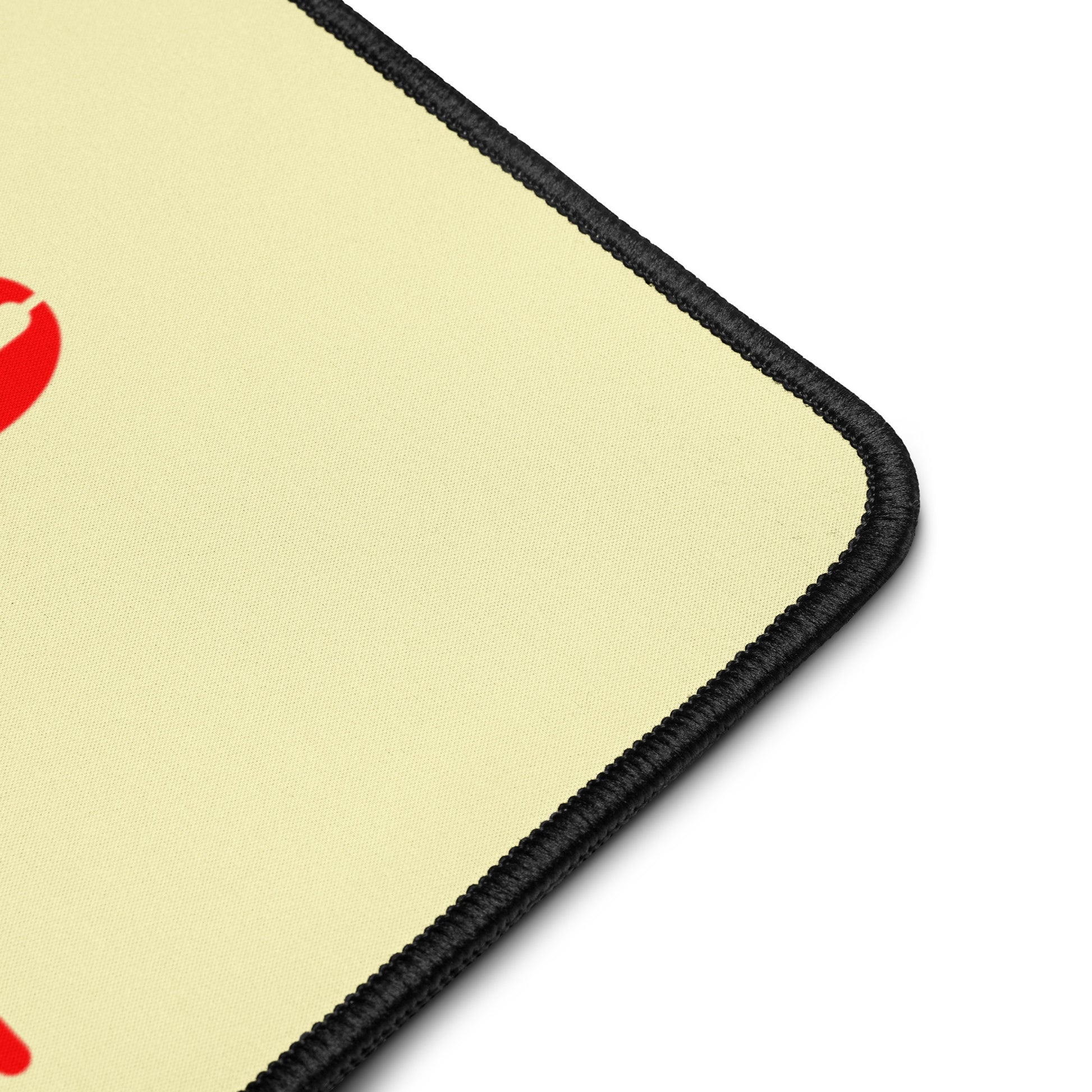 Close-up of Go To Work desk mat showing edge-to-edge graphic print on smooth polyester surface with hemmed edges