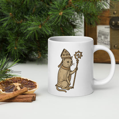 Medieval pope cat in bishop's robes and mitre holding a crozier — illustrated in a vintage manuscript style on a white glossy ceramic mug