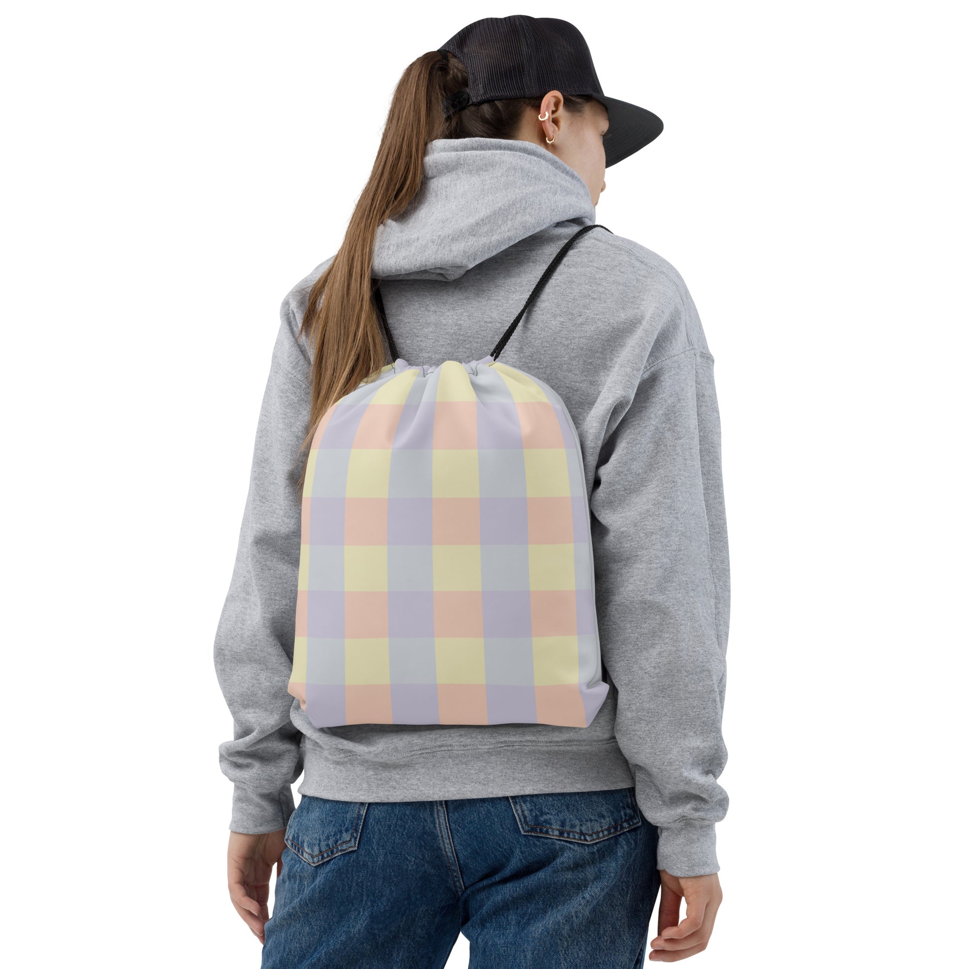 Just Color drawstring bag with pastel colorblock all-over print — Lemon Icing, Nimbus Cloud, Peach Dust, and Orchid Tint. Front view.