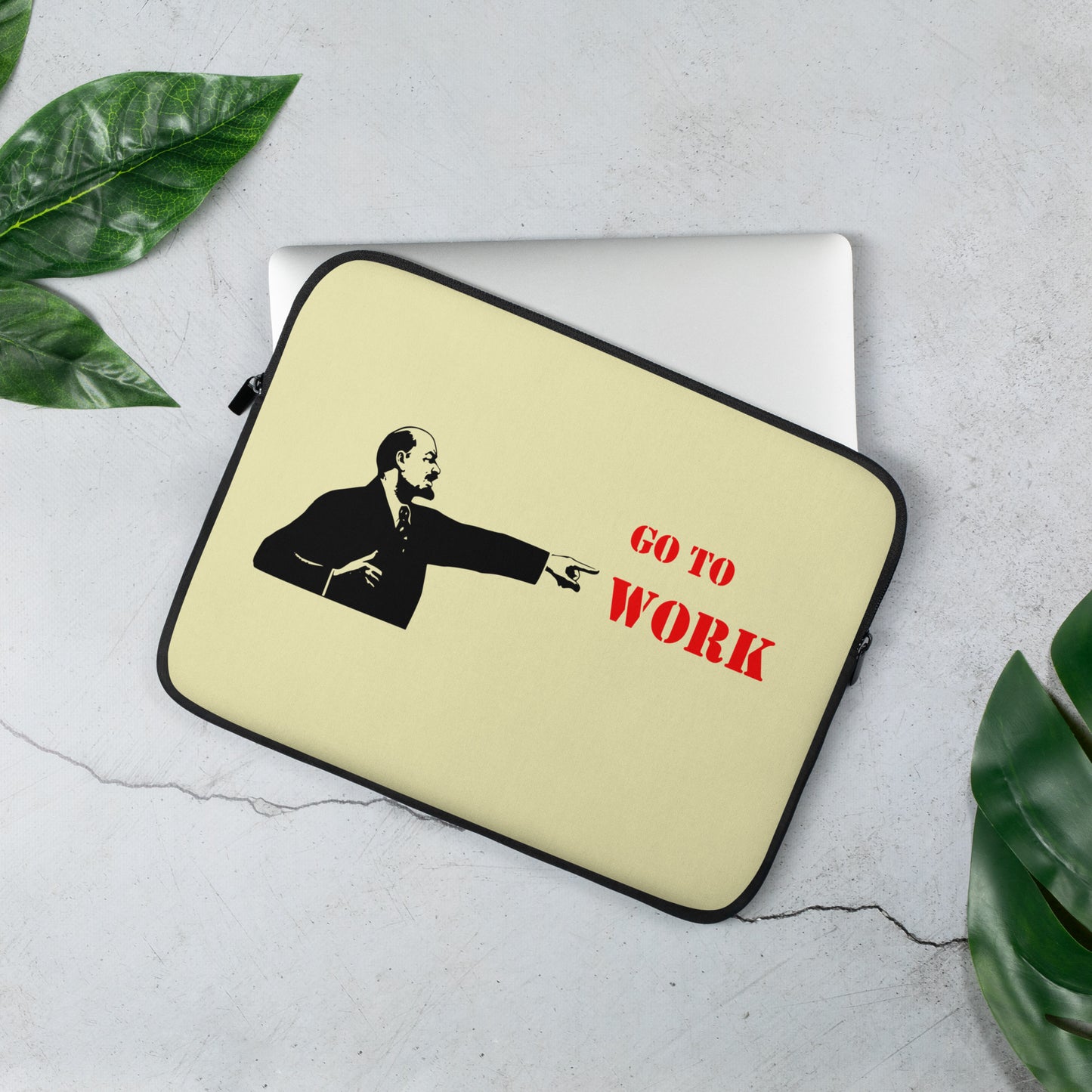 Go To Work laptop sleeve with bold Soviet-style Lenin graphic and red typography on neoprene, flat lay on desk