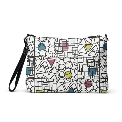 Faux leather crossbody bag printed with a bold geometric CMYK pattern — repeating circles, triangles and squares in cyan, magenta, yellow and black on white. Shape. Check. Repeat. by MWL.
