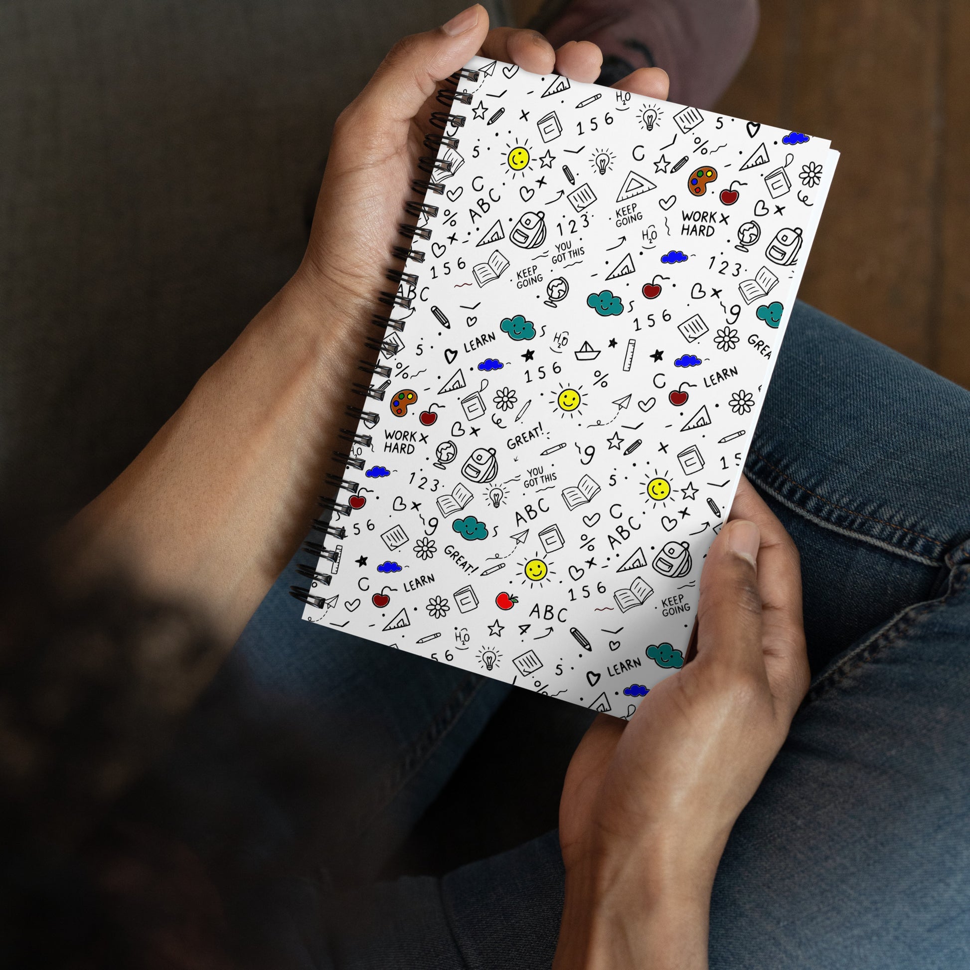  Wire-bound notebook with colorful hand-drawn school doodle illustration — books, pencils, numbers and happy faces on soft-touch cover