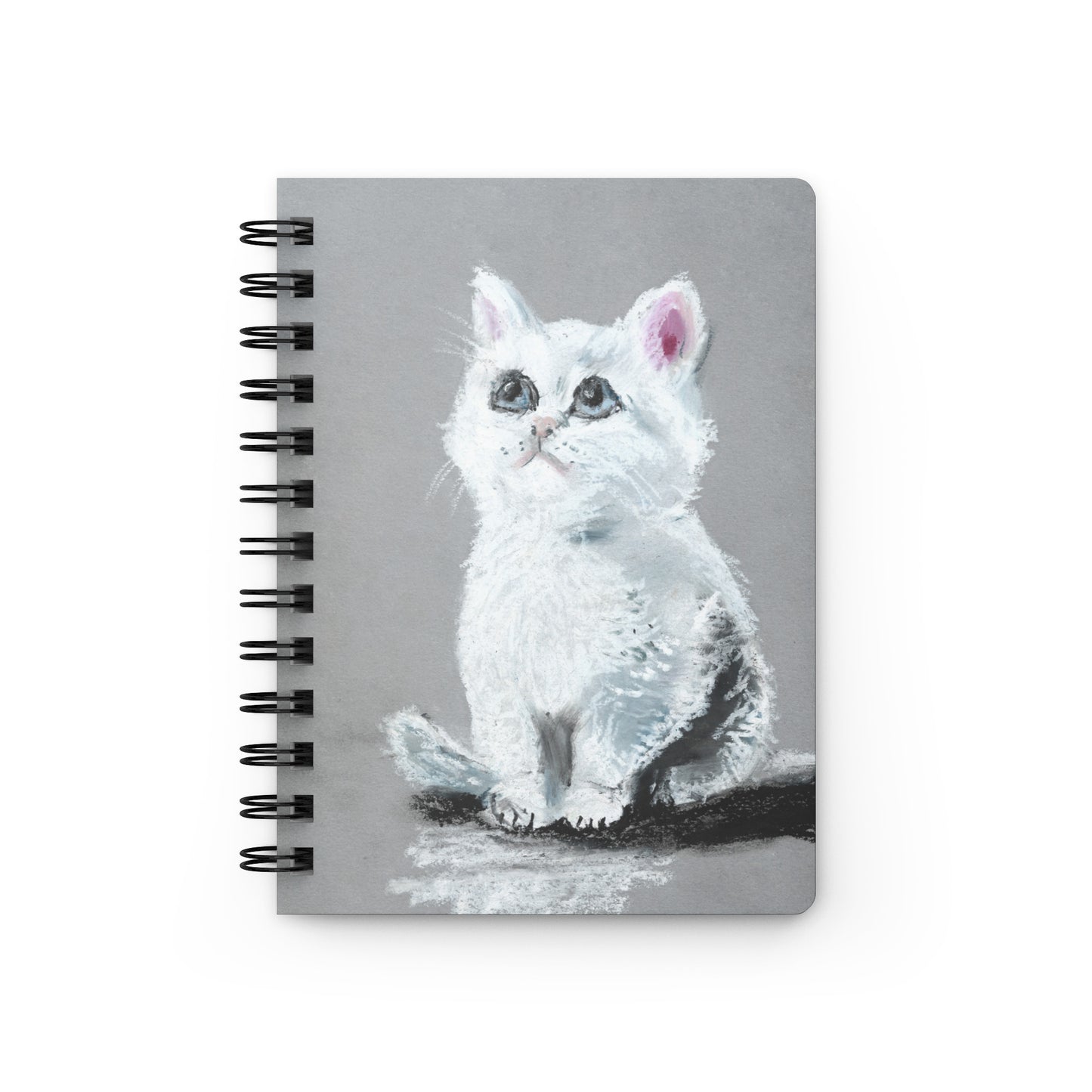 Spiral-bound journal with glossy laminated cover featuring a soft pastel drawing of a white kitten with blue eyes, artwork by artist Lena Kloper